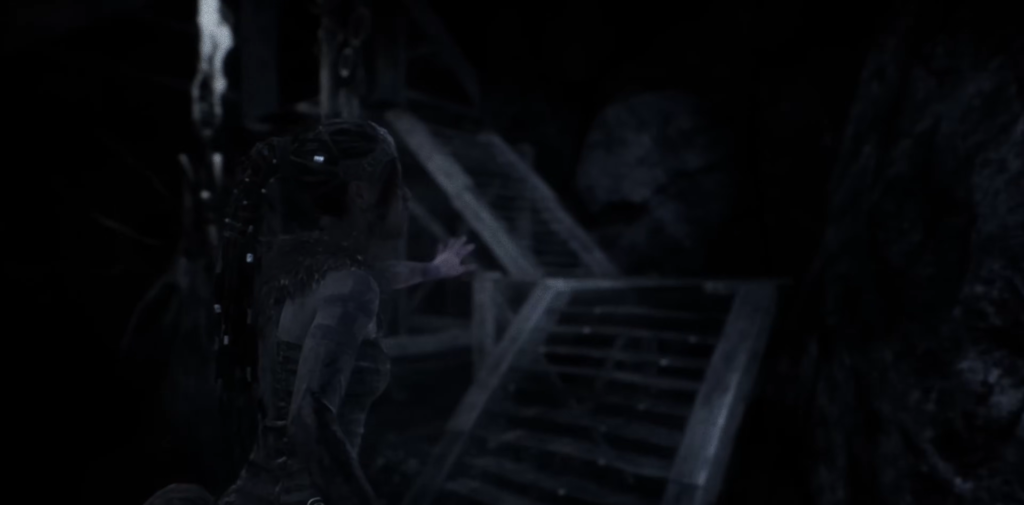 Лара Крофт из Tomb Raider тянется к лестнице в пещере