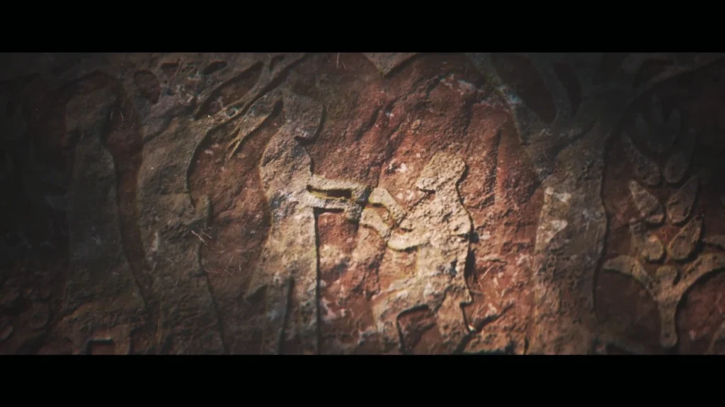 Наскальный рисунок человека, бьющего копьём животное на скале