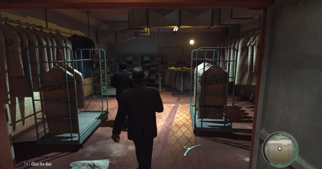 Персонаж Mafia II идет по прачечной склада одежды