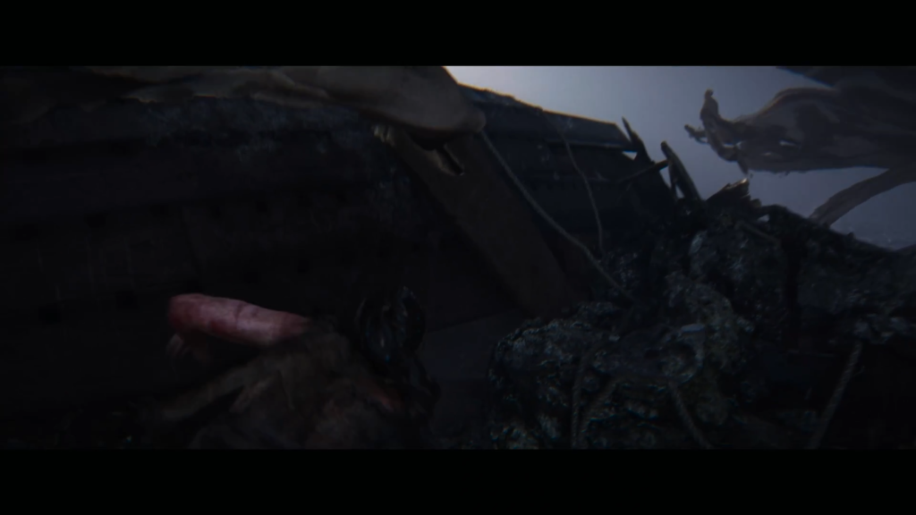 Чёрный дракон лежит на скалах под дождём