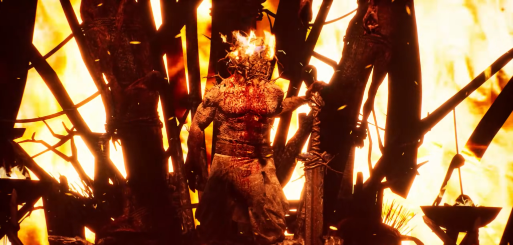 Обгоревший воин держит меч на фоне огня