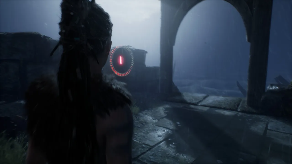 Сенуа из Hellblade смотрит на красный портал в руинах