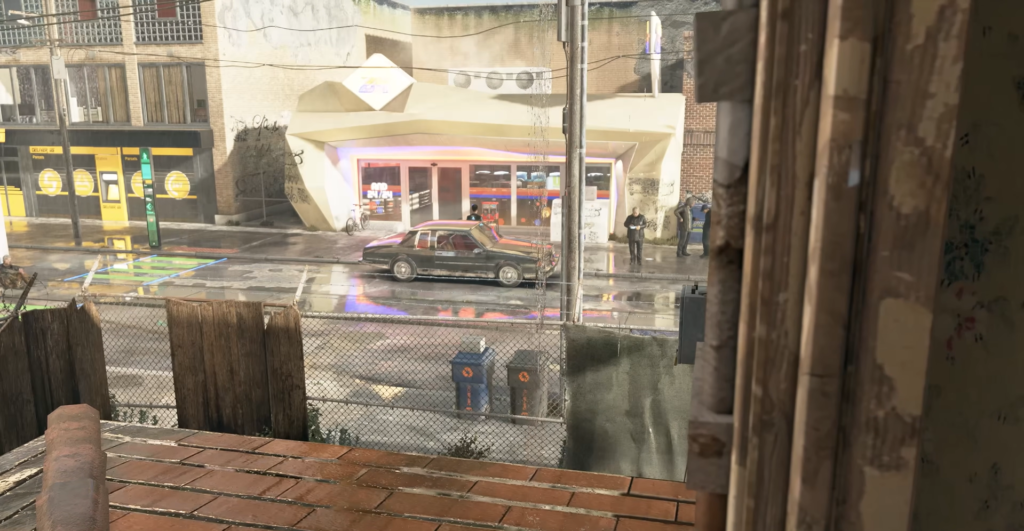 Машина едет по мокрой улице мимо магазина