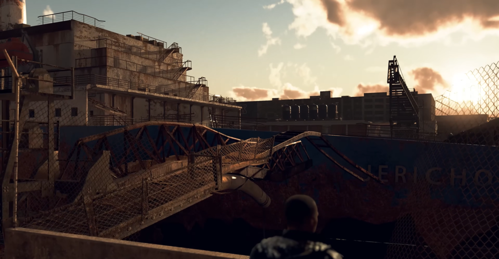 Человек смотрит на ржавый корабль на закате