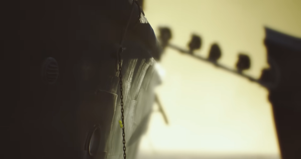 Цепь свисает с борта корабля на закате