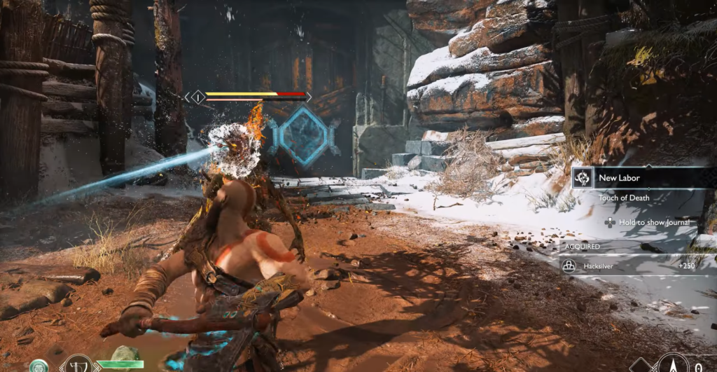 Кратос атакует врага в снежном ущелье God of War