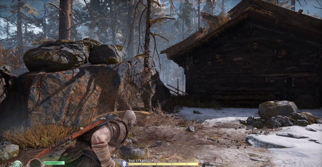 Кратос крадется у деревянной хижины в лесу