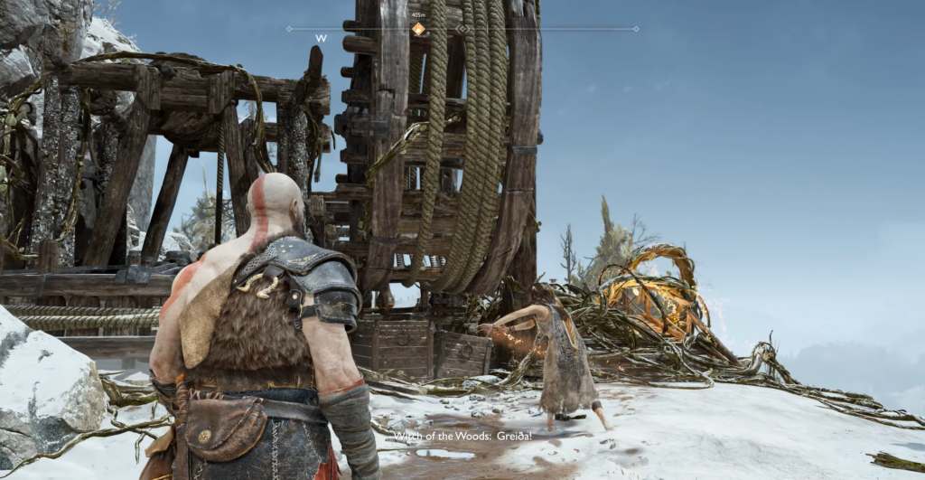 Кратос стоит у деревянного механизма в снегу God of War