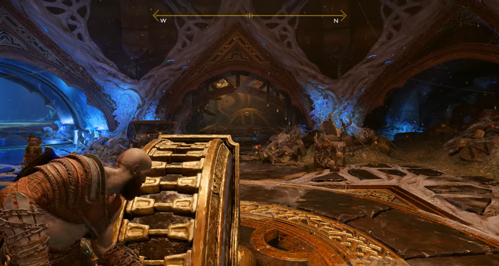 Кратос толкает золотое колесо в пещере God of War