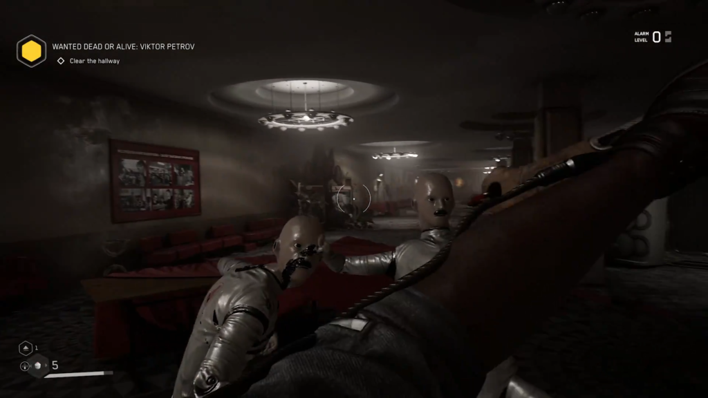Woman standing in dark industrial room with fans