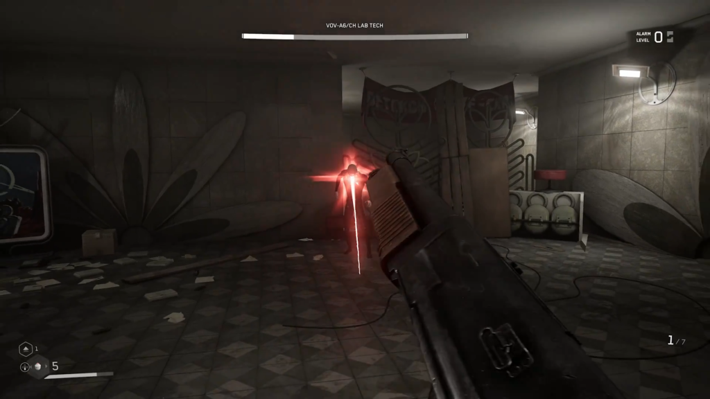 Gloved hand reaching for reel in industrial room