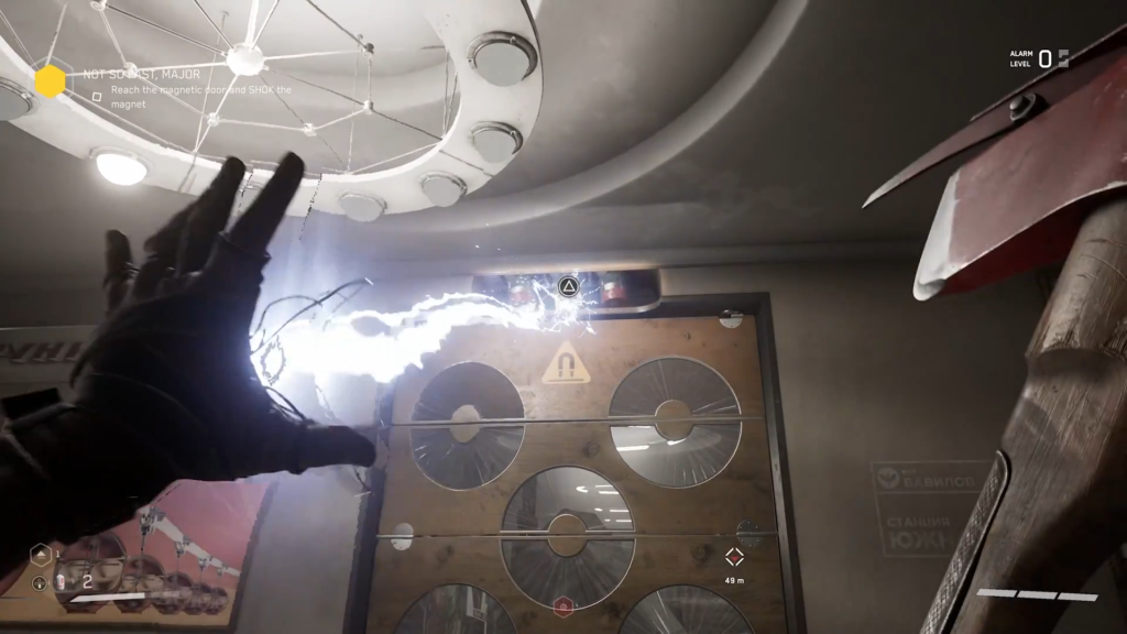 Glowing monitors fill dark industrial room with cables