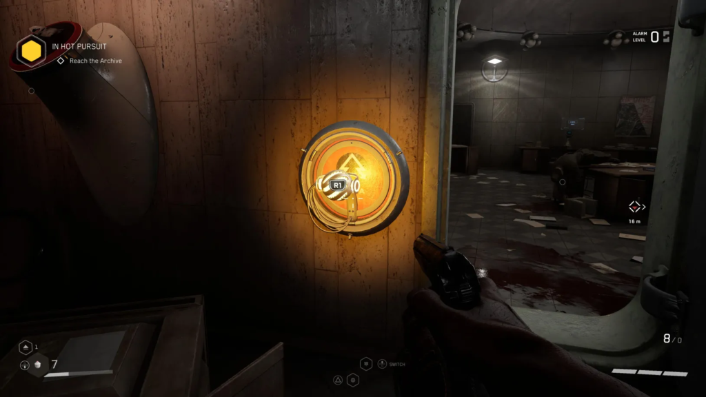 Man crouching over body in bloodstained corner room