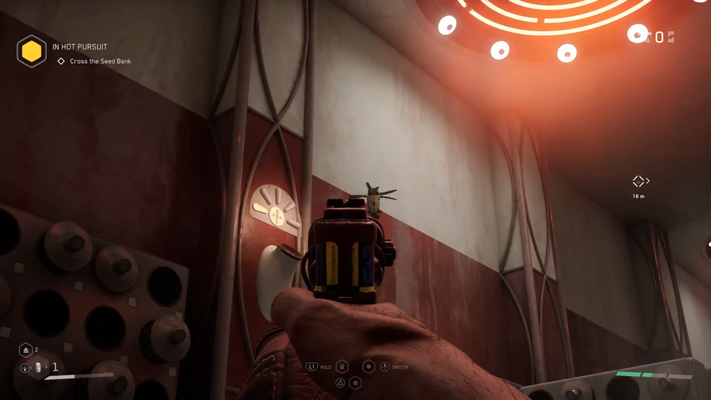 Gloved hand reaches toward blue robot on wall