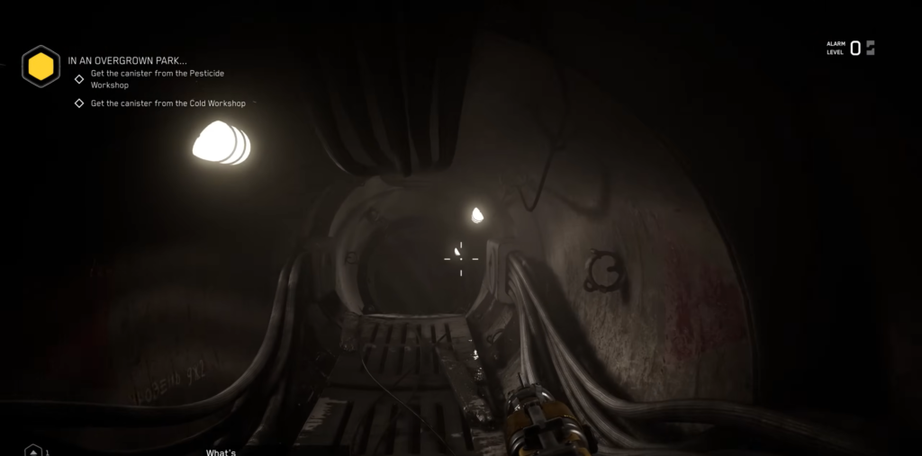 Blonde woman aiming pistol at workshop desk