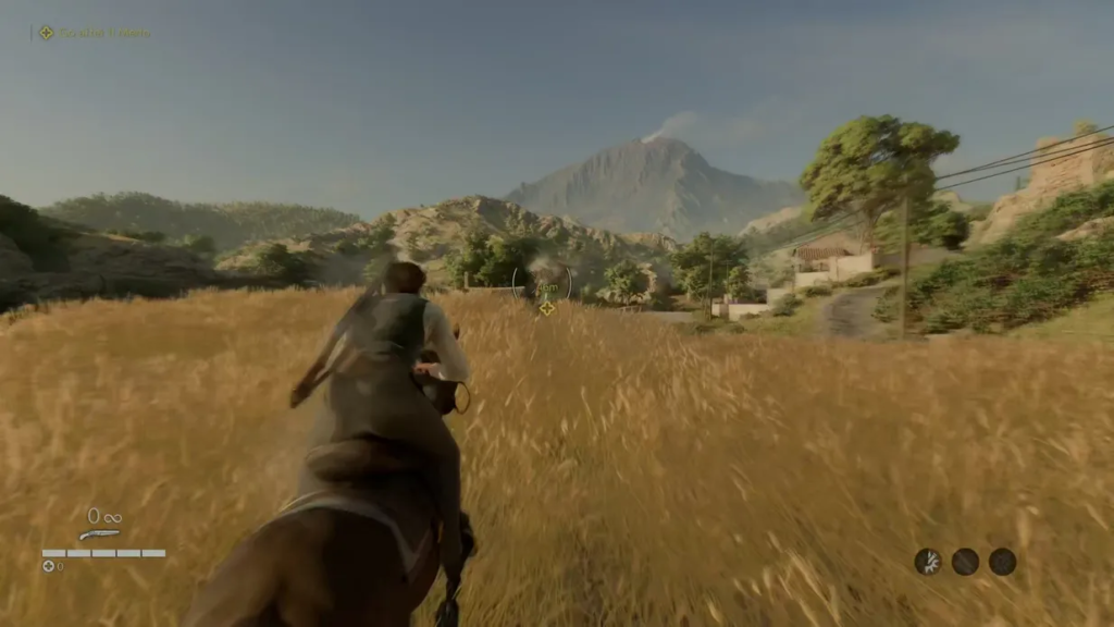 Всадник скачет по полю к горам и деревне