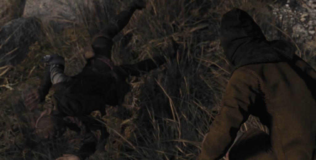 Два человека дерутся на травянистой земле