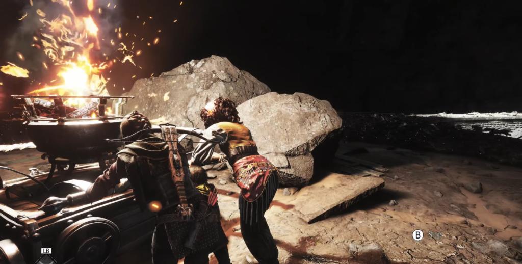 Два персонажа толкают вагонетку у горящих обломков в пещере